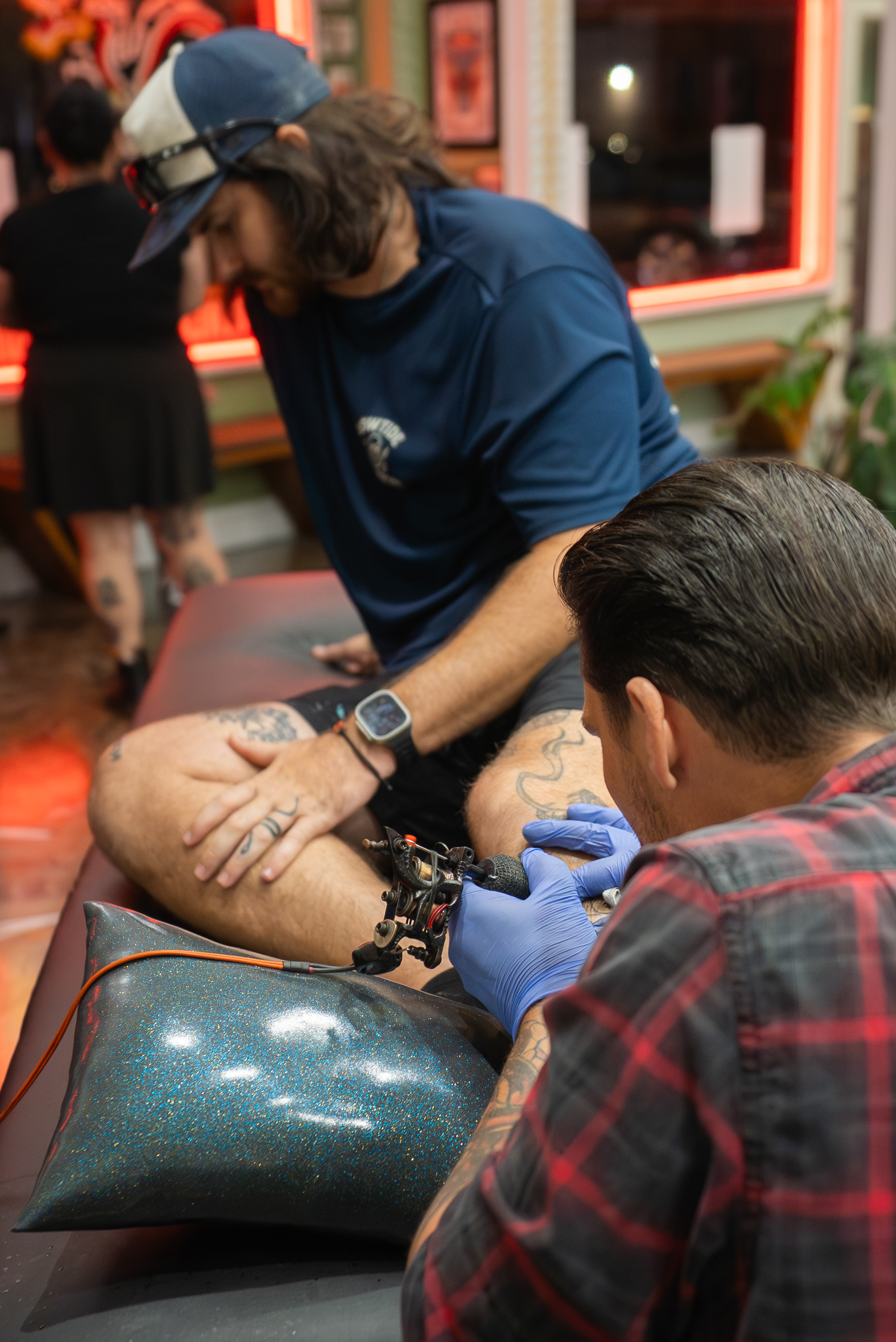 Derrick tattooing a client