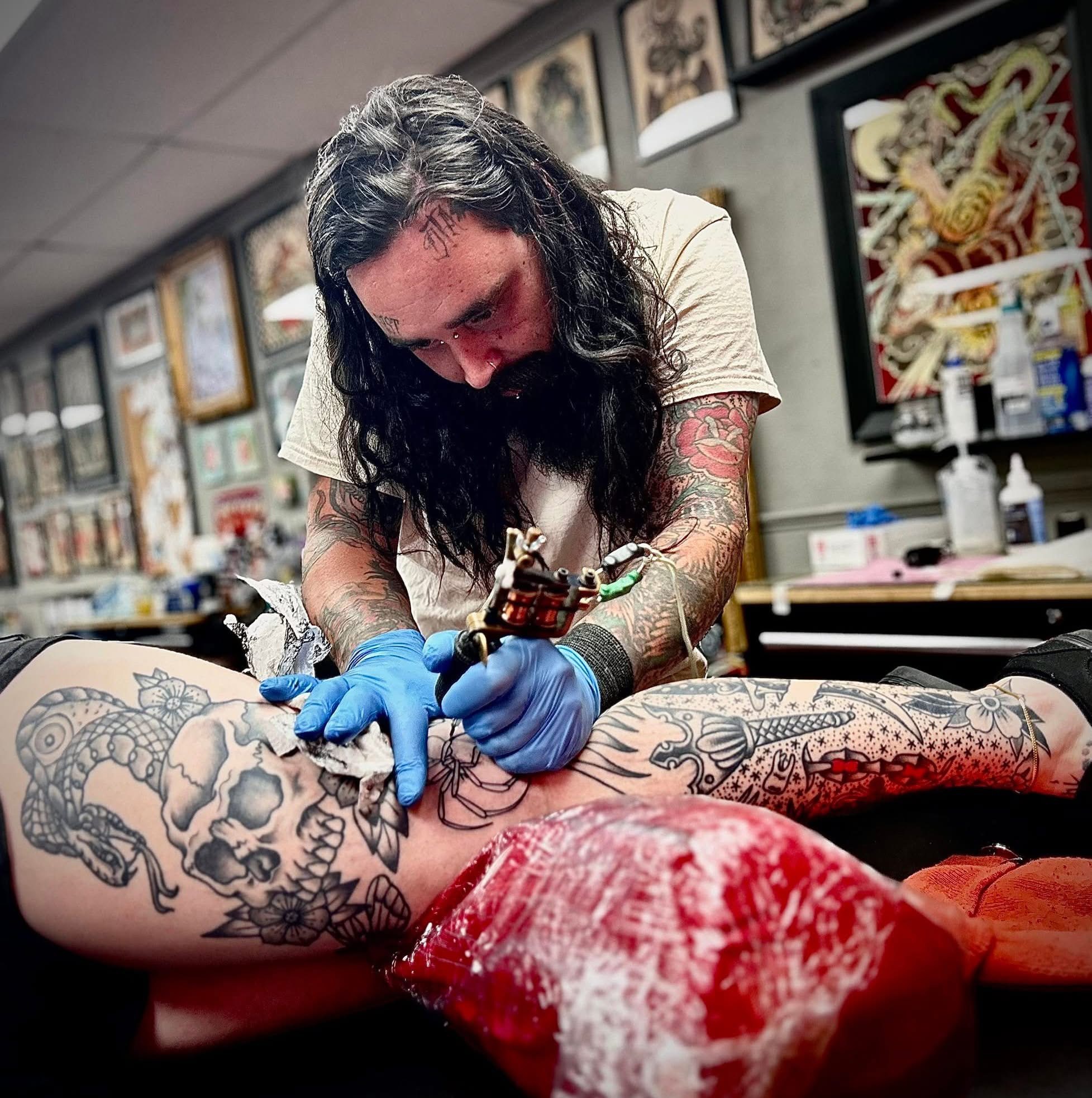 Billy tattooing a client