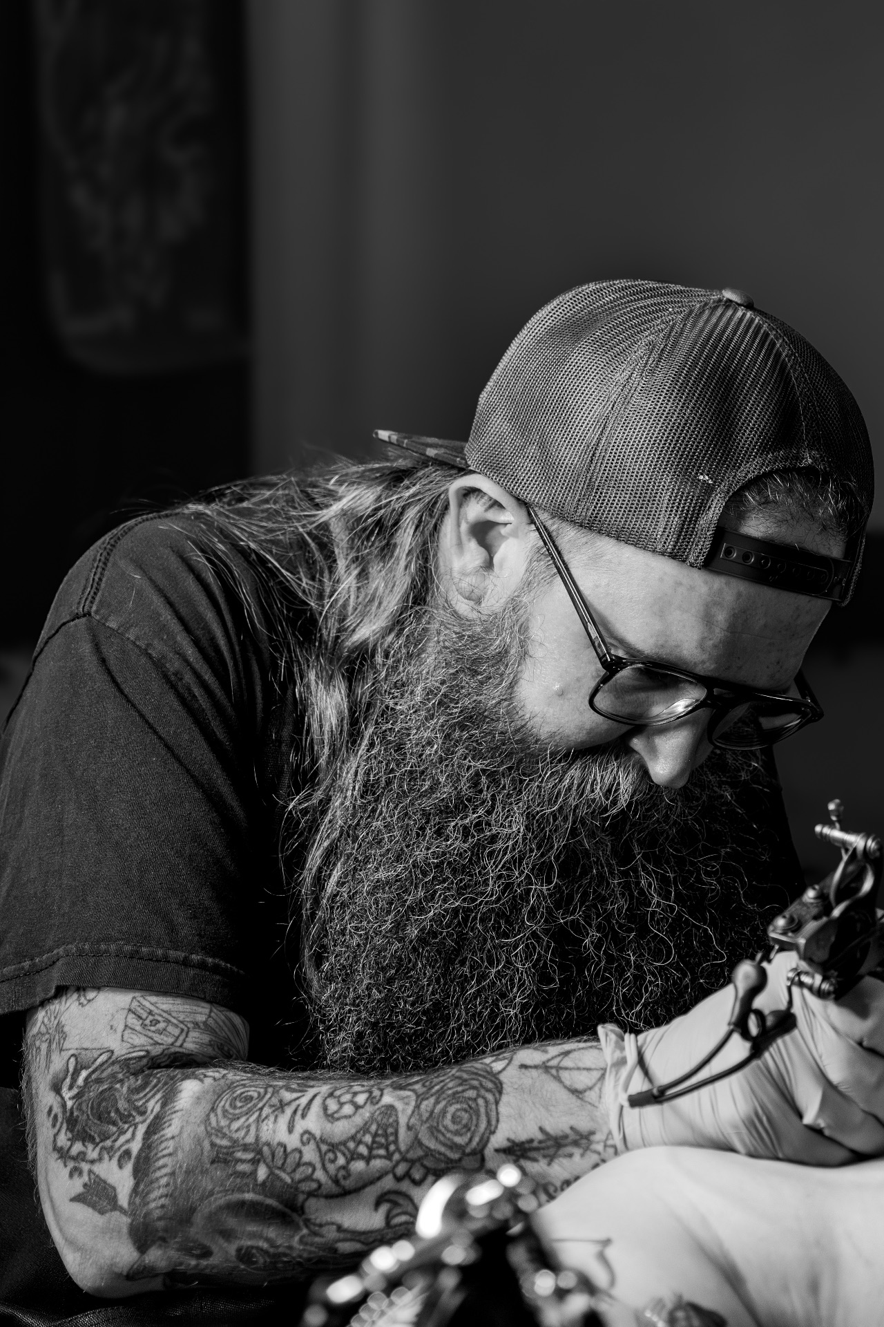 Beau tattooing a client at Atomic Tattoos Brandon Mall