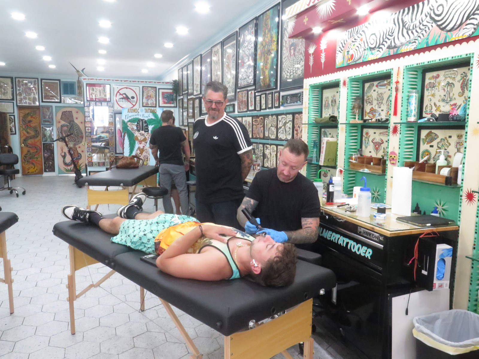 Jake tattooing a client at Atomic Tattoos Clearwater Beach